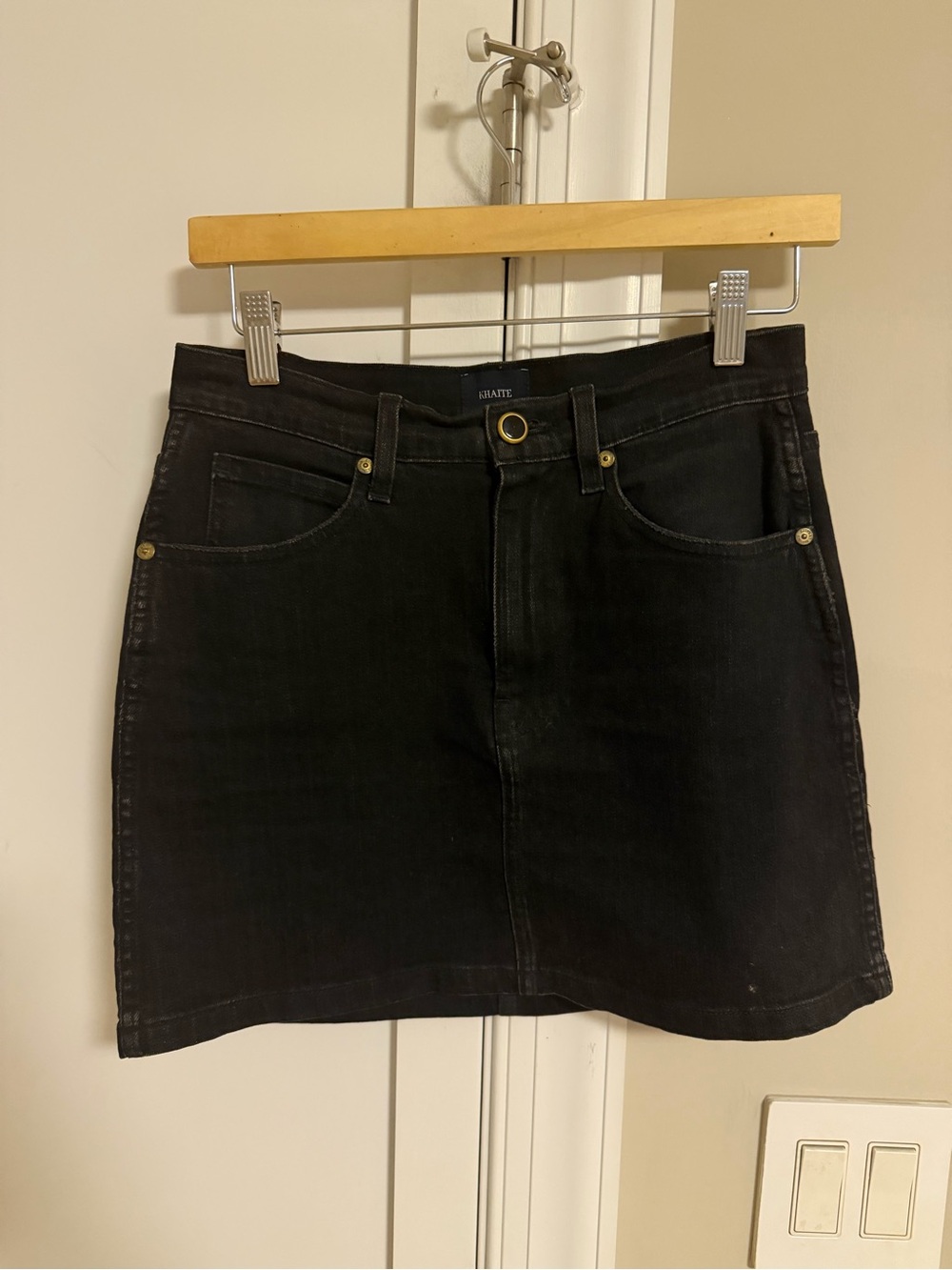 KHAITE Dolly Denim Mini Skirt in Black